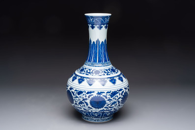 A Chinese blue and white 'flower scroll' bottle vase, Xuantong mark, 20th C.
