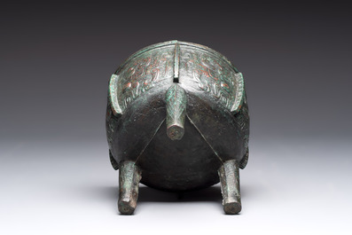 A Chinese archaic bronze tripod food vessel with 'taotie' design, 'ding 鼎', Western Zhou