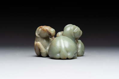 A Chinese celadon jade group of three goats on wooden stand, 19/20th C.