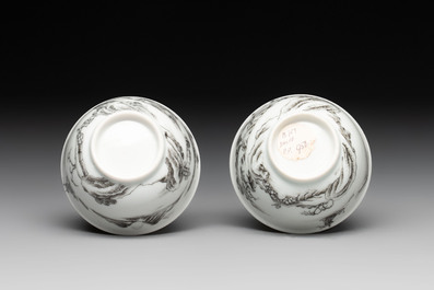 A pair of Chinese grisaille and iron-red 'landscape' cups and saucers, Yongzheng/Qianlong