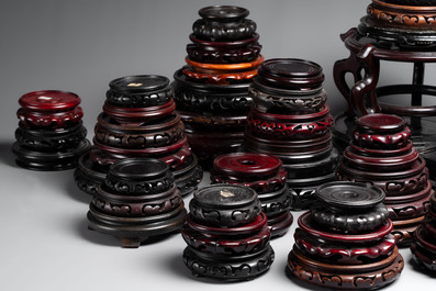 A collection of 100 Chinese wooden stands, 19/20th C.