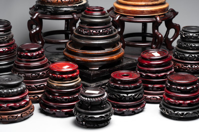 A collection of 100 Chinese wooden stands, 19/20th C.