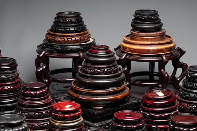 A collection of 100 Chinese wooden stands, 19/20th C.