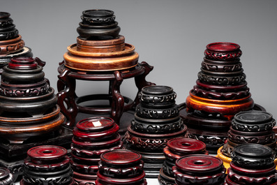 A collection of 100 Chinese wooden stands, 19/20th C.
