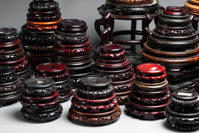A collection of 100 Chinese wooden stands, 19/20th C.
