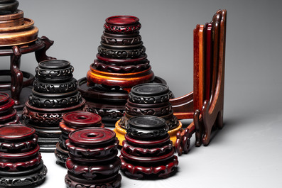 A collection of 100 Chinese wooden stands, 19/20th C.