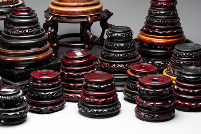 A collection of 100 Chinese wooden stands, 19/20th C.