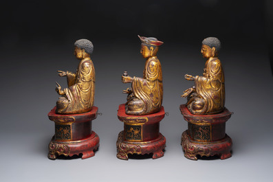 A set of three Chinese or Vietnamese gilt-lacquered wooden sculptures of Buddha, 18/19th C.
