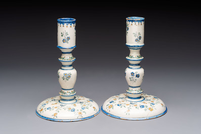 A pair of polychrome French faience candlesticks, 18th C.