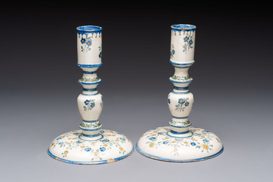 A pair of polychrome French faience candlesticks, 18th C.