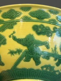 An imperial Chinese green-enamelled yellow-ground 'playing boys' bowl, Yongzheng mark and of the period