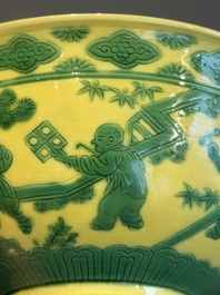 An imperial Chinese green-enamelled yellow-ground 'playing boys' bowl, Yongzheng mark and of the period