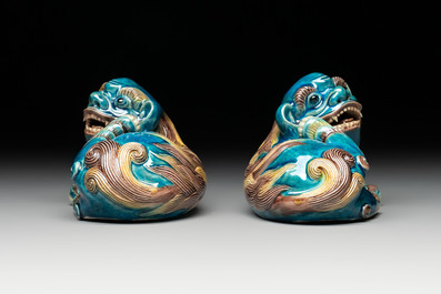 A pair of Chinese polychrome lions and a celadon-glazed goat, 20th C.
