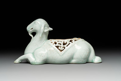 A pair of Chinese polychrome lions and a celadon-glazed goat, 20th C.
