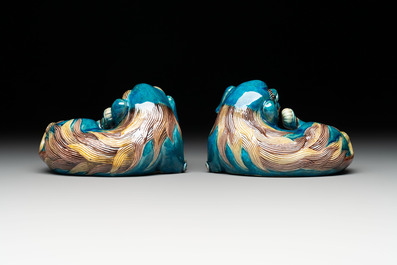 A pair of Chinese polychrome lions and a celadon-glazed goat, 20th C.