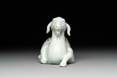 A pair of Chinese polychrome lions and a celadon-glazed goat, 20th C.