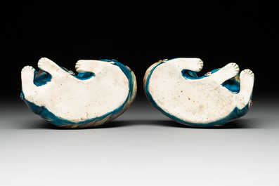 A pair of Chinese polychrome lions and a celadon-glazed goat, 20th C.