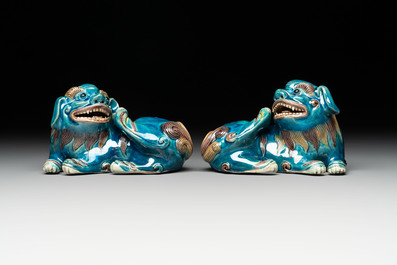 A pair of Chinese polychrome lions and a celadon-glazed goat, 20th C.