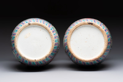 A pair of Chinese famille rose vases with narrative design on wooden stands, 19th C.