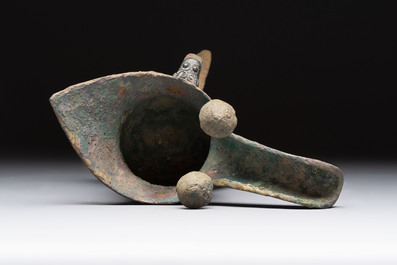 A Chinese archaic bronze wine vessel with taotie design, 'jue 爵', Zhou