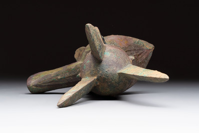 A Chinese archaic bronze wine vessel with taotie design, 'jue 爵', Zhou