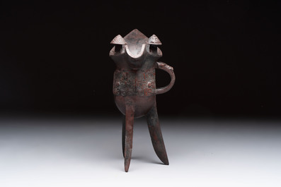 A Chinese archaic bronze wine vessel with taotie design, 'jue 爵', Zhou