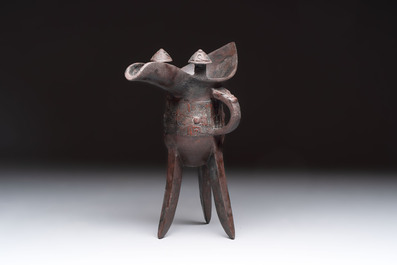 A Chinese archaic bronze wine vessel with taotie design, 'jue 爵', Zhou