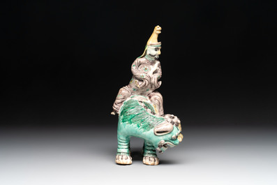 A Chinese verte biscuit 'Sogdian riding a Buddhist lion' group, 19th C.