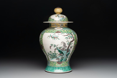 A pair of Chinese verte-biscuit 'cranes and flowers' vases and covers, 19th C.