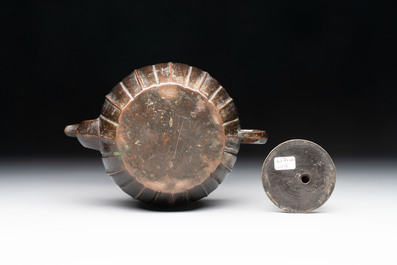 A Chinese bronze teapot and cover with a lion-shaped finial, Yuan