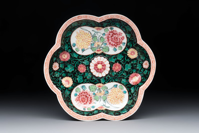 A Chinese famille rose black-ground teapot and stand with floral design, Yongzheng/Qianlong