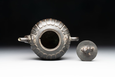 A Chinese bronze teapot and cover with a lion-shaped finial, Yuan