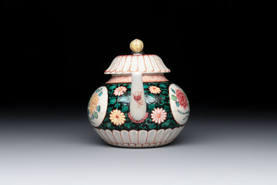 A Chinese famille rose black-ground teapot and stand with floral design, Yongzheng/Qianlong