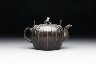 A Chinese bronze teapot and cover with a lion-shaped finial, Yuan
