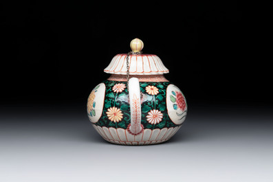 A Chinese famille rose black-ground teapot and stand with floral design, Yongzheng/Qianlong