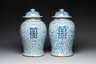 Two Chinese blue and white 'double happiness' covered vases and two 'meiping' vases, Kangxi mark, 19th C.