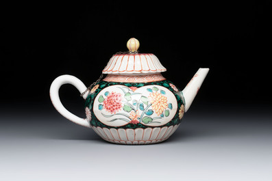 A Chinese famille rose black-ground teapot and stand with floral design, Yongzheng/Qianlong