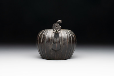 A Chinese bronze teapot and cover with a lion-shaped finial, Yuan