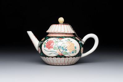A Chinese famille rose black-ground teapot and stand with floral design, Yongzheng/Qianlong