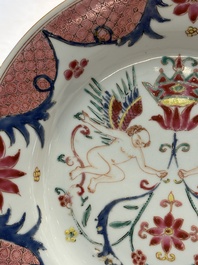 A pair of Chinese famille rose 'winged putti' plates, Yongzheng/Qianlong