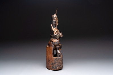 A Chinese gilt-lacquered wooden sculpture of a guardian, 19th C.