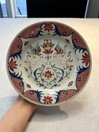 A pair of Chinese famille rose 'winged putti' plates, Yongzheng/Qianlong