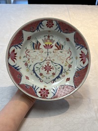 A pair of Chinese famille rose 'winged putti' plates, Yongzheng/Qianlong