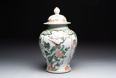 A Chinese famille verte covered vase, a pair of blue and white jars on wooden stands and two jars, 19th C.