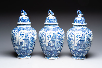A blue and white Dutch Delft garniture of five vases and covers, 19th C.