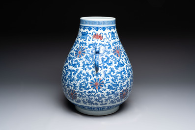 A Chinese blue, white and copper-red 'hu' vase with lotus scrolls, Qianlong mark, 19th C.