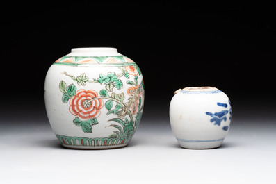 A Chinese famille verte covered vase, a pair of blue and white jars on wooden stands and two jars, 19th C.