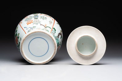 A Chinese famille verte covered vase, a pair of blue and white jars on wooden stands and two jars, 19th C.