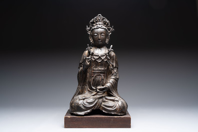 A large Chinese bronze Bodhisattva on wooden stand, Ming