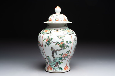 A Chinese famille verte covered vase, a pair of blue and white jars on wooden stands and two jars, 19th C.